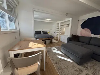 a living room with a couch and a table at Welcoming Studio Walk to Palisades Resort and Lifts in Olympic Valley