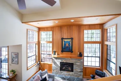 a living room with a fireplace and windows at Family Escape Minutes to Northstar EV Charger WandD in Truckee
