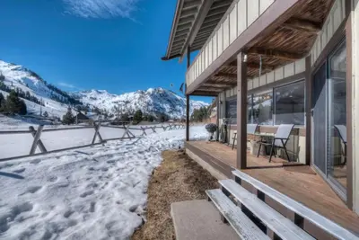 a house in the snow with a table and chairs at Serene Condo by Palisades Base and Golf Course in Olympic Valley