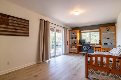 a room with a bed and a desk in a room at Riverfront Serenity with Stunning Views in Mariposa