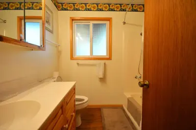 a bathroom with a toilet and a sink and a window at Cozy Cabin with Boat Slip Winter SpecialEnds512 in Bass Lake