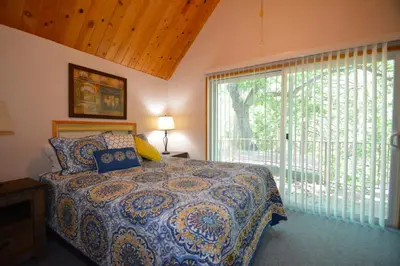 a bedroom with a bed and a large window at Cozy Cabin with Boat Slip Winter SpecialEnds512 in Bass Lake