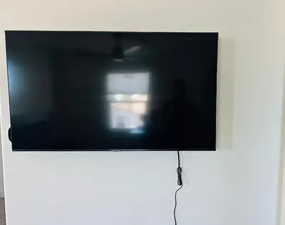 a flat screen tv hanging on a wall at Spacious 4BR-3BA Cozy and Modern in Elk Grove in Elk Grove