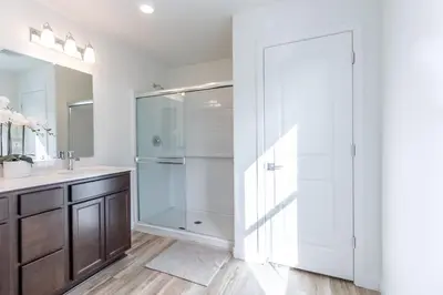 a bathroom with a walk in shower next to a sink at Spacious 4BR-3BA Cozy and Modern in Elk Grove in Elk Grove