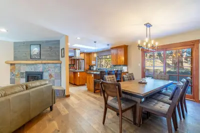 a kitchen and dining room with a table and a couch at Tranquil Stay Sauna, Rooftop and Nature Views in Incline Village