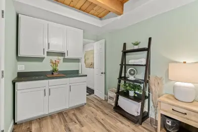 a kitchen with white cabinets and a shelf at MtnCity Views 4BR Firepit FamilyRetreat NearUNR in Reno