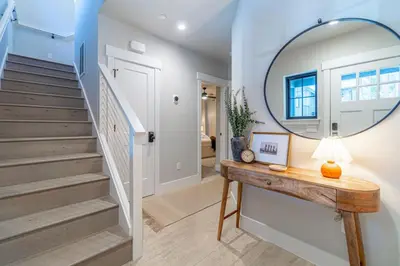 a hallway with stairs and a mirror on a table at Elegant Tahoe Escape Comfort and Style Combined in Glenbrook