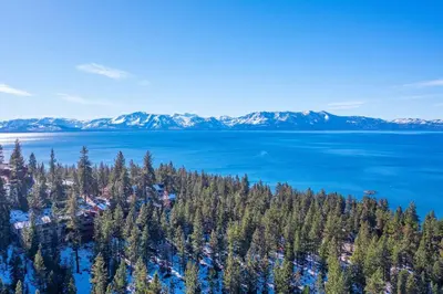 an aerial view of a lake with trees and mountains at Elegant Tahoe Escape Comfort and Style Combined in Glenbrook