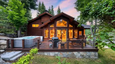 a log cabin with a hot tub on a deck at Cedars at Palisades by AvantStay Hot Tub Resort Access and Mountain Views in Olympic Valley