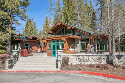 a building with a sign in front of it at Charmed Cabin at Tahoe Donner by Tahoe Getaways - 2BR w HOA Access in Truckee