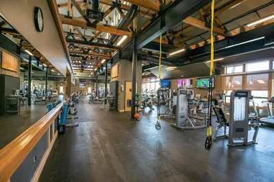 a gym with several treadmills and machines in it at Charmed Cabin at Tahoe Donner by Tahoe Getaways - 2BR w HOA Access in Truckee