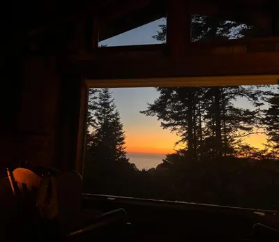 a view of the ocean from a window at Redwoods Oceanview Retreat