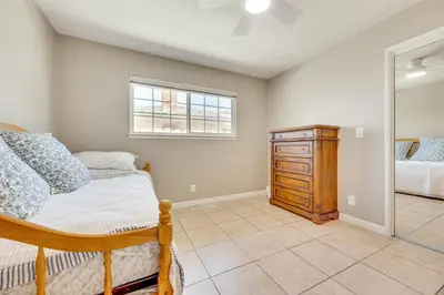 a bedroom with a bed and a dresser and a window at Shop, Hike and Explore Fresno Home with Private Pool! in Fresno