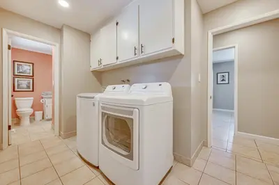 a white washer and dryer in a laundry room at Shop, Hike and Explore Fresno Home with Private Pool! in Fresno
