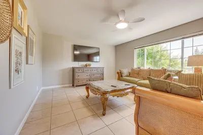 a living room with a couch and a table at Shop, Hike and Explore Fresno Home with Private Pool! in Fresno