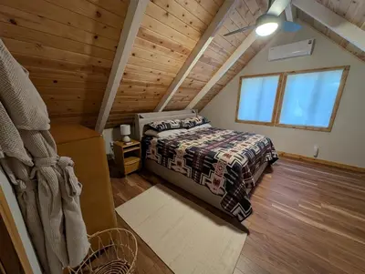 a bedroom in a log cabin with a bed at Mountain Haven Near Kirkwood Resort! in Pioneer