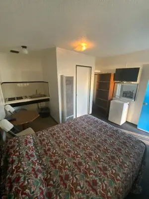a hotel room with a bed in a room at Hotel Paisano in Reedley