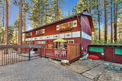 a red and white house in the woods at 1510 Wildwood, Sitzmark 4 home in South Lake Tahoe