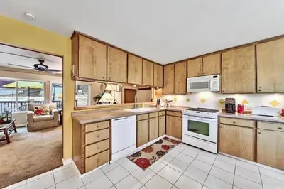 a large kitchen with wooden cabinets and white appliances at 1510 Wildwood, Sitzmark 4 home in South Lake Tahoe