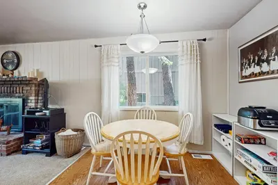 a dining room with a table and chairs and a window at The Bear's Den in South Lake Tahoe
