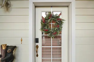 a christmas wreath on the door of a house at Scenic Mountain Views w Heated Pool, Game Room, and Hottubs in Oakhurst