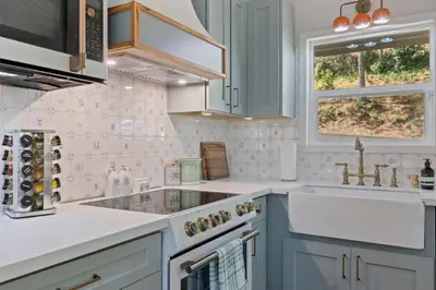 a kitchen with blue cabinets and a sink at Yosemite family getaway w lake, golf, horses, pool in Groveland