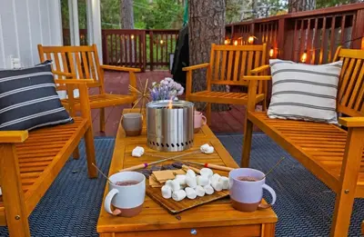 a table on a porch with mugs of coffee and popcorn at Yosemite family getaway w lake, golf, horses, pool in Groveland