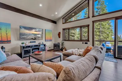 a living room with two couches and a table at Agate Bay Getaway with Lake Views in Carnelian Bay