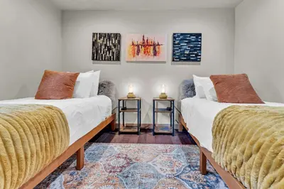 two beds in a room with two candles on tables at Agate Bay Getaway with Lake Views in Carnelian Bay