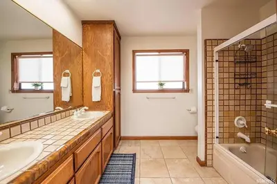 a large bathroom with a tub and a sink and a tubermott at 625 Alpine Drive home in South Lake Tahoe