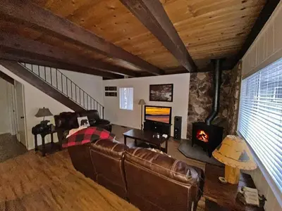 a living room with a leather couch and a fireplace at 2708 Springwood Drive cabin in South Lake Tahoe