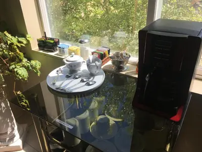 a glass counter top with a table with dishes on it at Shady Lady Bed and Breakfast in Scottys Junction