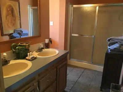 a bathroom with two sinks and a shower at Shady Lady Bed and Breakfast in Scottys Junction