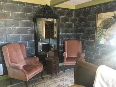 a room with two chairs and a mirror at Shady Lady Bed and Breakfast in Scottys Junction