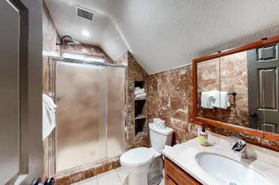 a bathroom with a shower and a toilet and a sink at Meadows Crossings in South Lake Tahoe