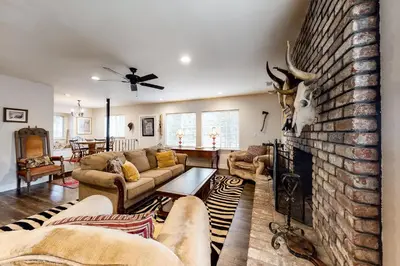 a living room with couches and a brick fireplace at Meadows Crossings in South Lake Tahoe