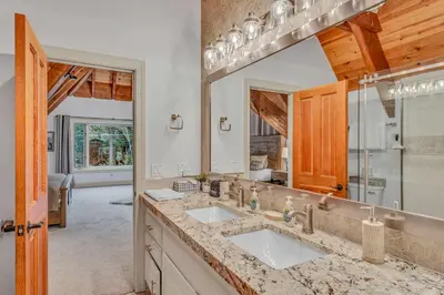 a bathroom with two sinks and a large mirror at Homewood Hideaway Family Friendly plus EV Charger in Homewood