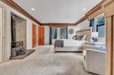 a bedroom with a bed and a fireplace at Homewood Hideaway Family Friendly plus EV Charger in Homewood