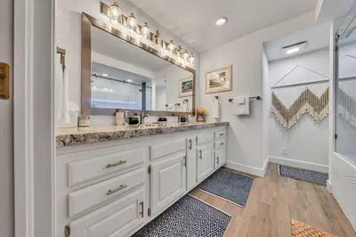 a bathroom with a sink and a large mirror at Homewood Hideaway Family Friendly plus EV Charger in Homewood