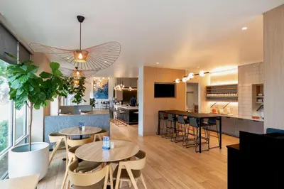 a dining room and kitchen with tables and chairs at Hyatt Place Sacramento Roseville in Roseville