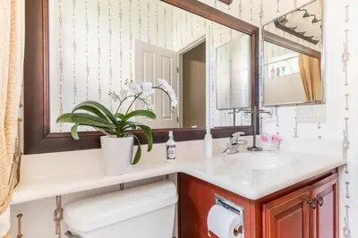 a bathroom with a sink and a mirror at Rose Garden in Sacramento