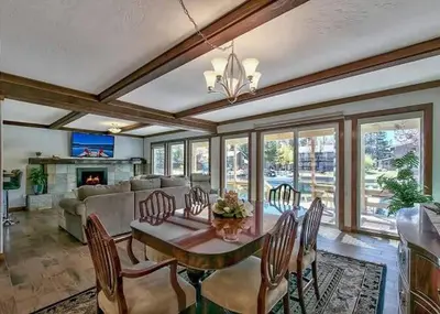 a living room with a table and chairs and a fireplace at 2148 Inverness Drive home in South Lake Tahoe