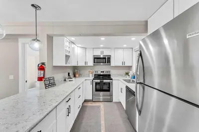 a kitchen with white cabinets and a stainless steel refrigerator at Modern Incline Village Escape Near Lake and Trails in Incline Village