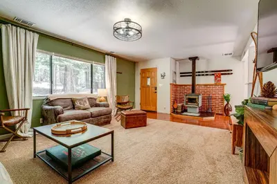 a living room with a couch and a fireplace at Hike and Ski! Cabin 20 Mi to Soda Springs Mtn Resort in Emigrant Gap