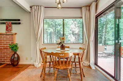 a dining room with a table and chairs and a window at Hike and Ski! Cabin 20 Mi to Soda Springs Mtn Resort in Emigrant Gap