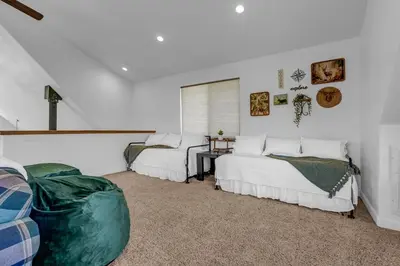 a bedroom with two beds and a couch in it at New Listing! North Fork Hideaway Sleeps 14! in Three Rivers