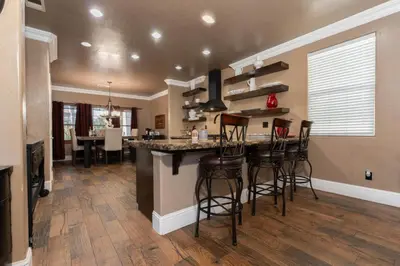 a kitchen with a bar with bar stools in a house at Private room--Ideal for working professionals-- in Tulare