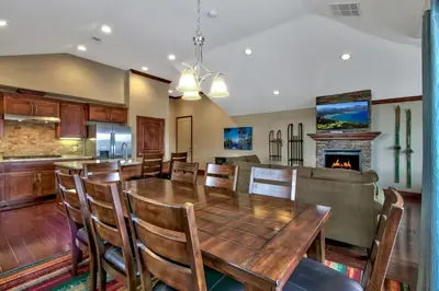 a dining room with a table and chairs and a fireplace at Conifer Chalet condo in South Lake Tahoe