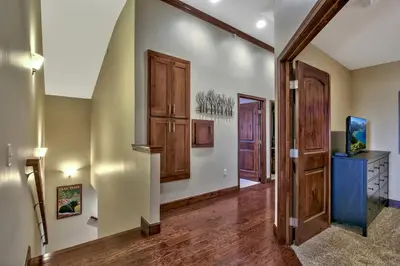 an empty hallway with a door and a television at Conifer Chalet condo in South Lake Tahoe
