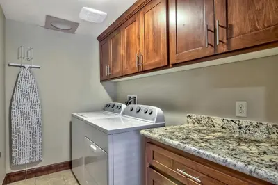 a kitchen with a washer and dryer and wooden cabinets at Conifer Chalet condo in South Lake Tahoe